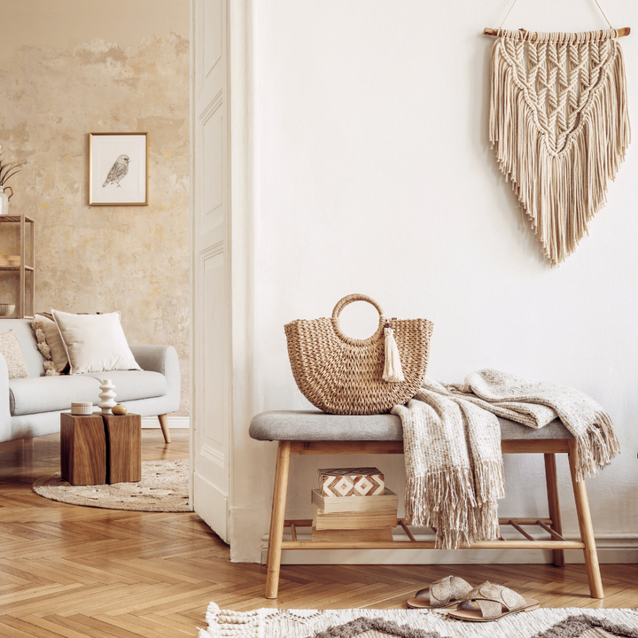 Eco-friendly minimalist home decor entryway leading into the living room. Includes macrame, rattan, natural wood, ceramics, natural colors, neutral colors